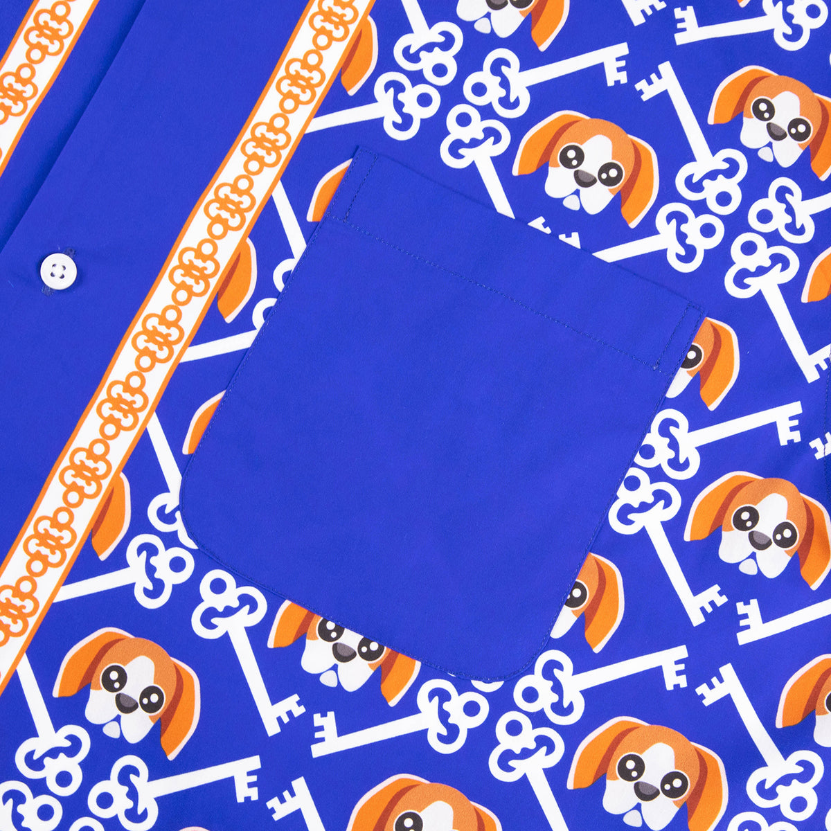 Detailed close-up of the Risk is Key fabric pattern showing Rik the Beagle mascot heads and brand logos on a premium lightweight shirt.