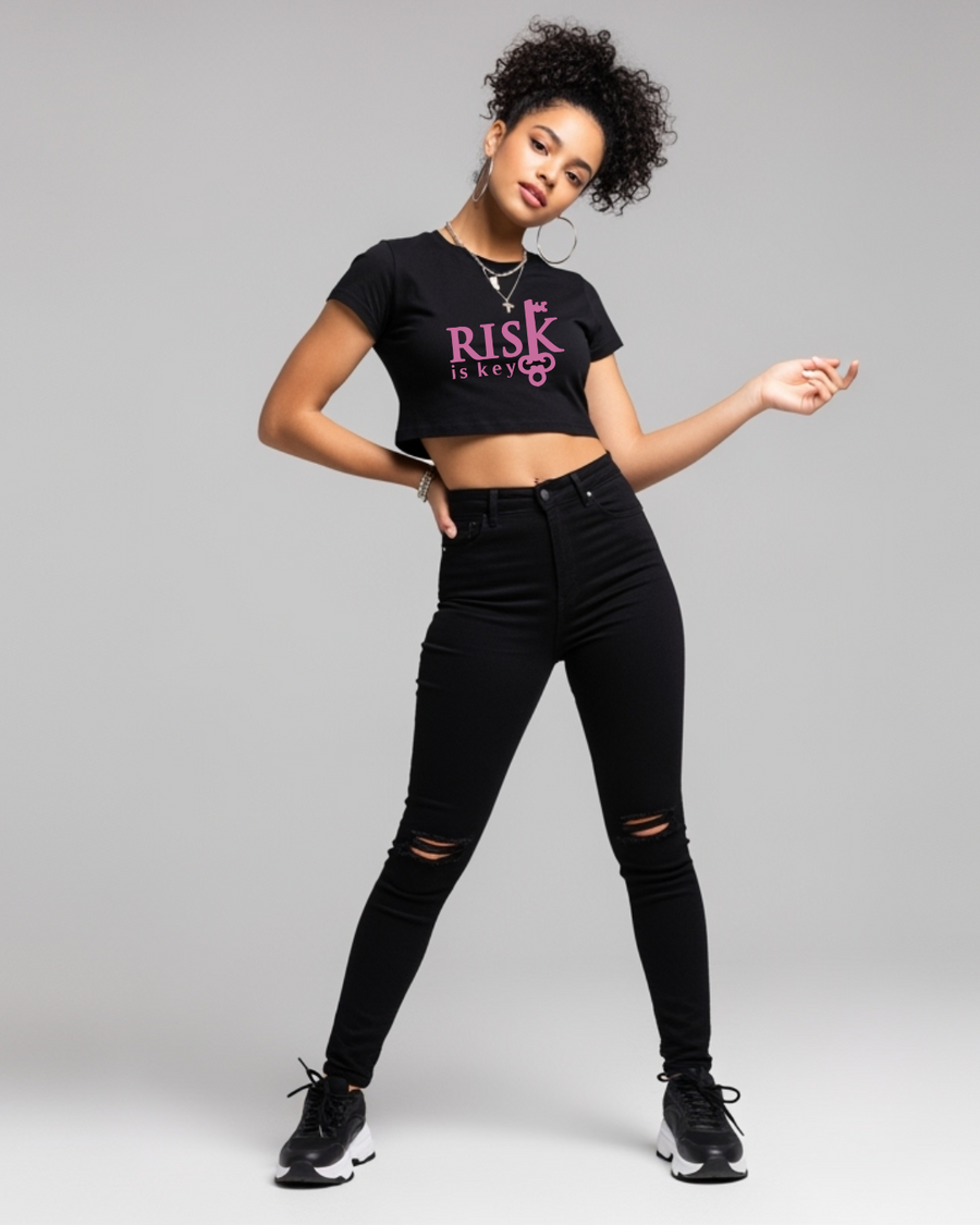 Women’s cropped denim short sleeve top in black and pink with Risk is Key signature logo on front.