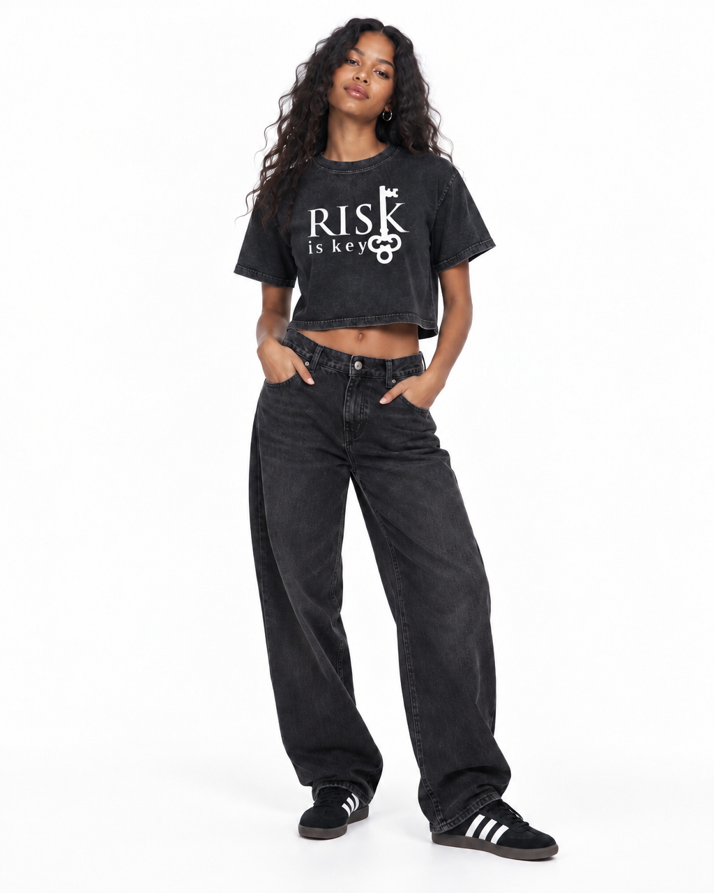 Model wearing The Risk Is Key women's relaxed fit cropped mineral wash tee paired with black jeans
