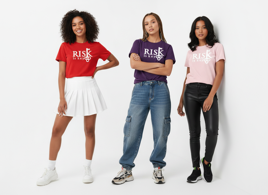 Three women wearing Risk Is Key signature logo t-shirts in red, purple, and pink on a white background.